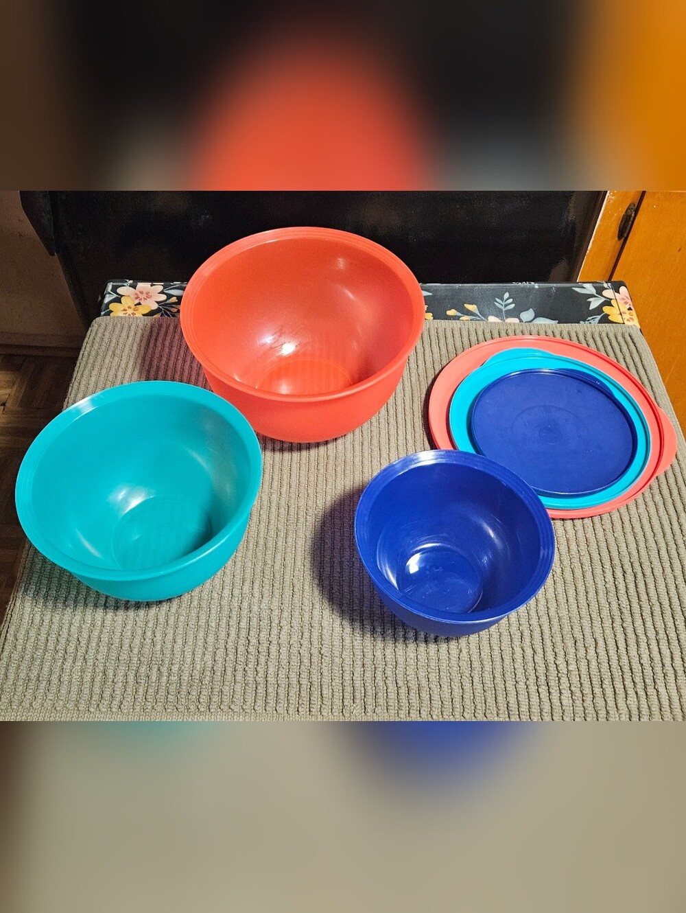 Tupperware mixing bowls and lids set in teal, coral, and blue